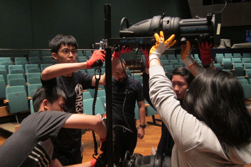 Working together as a team to rig lights in theatre
